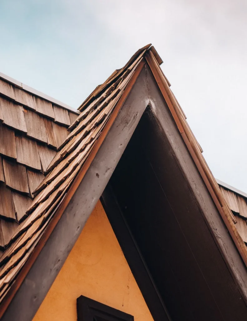 Roofer checking an old house roof in Allen Texas