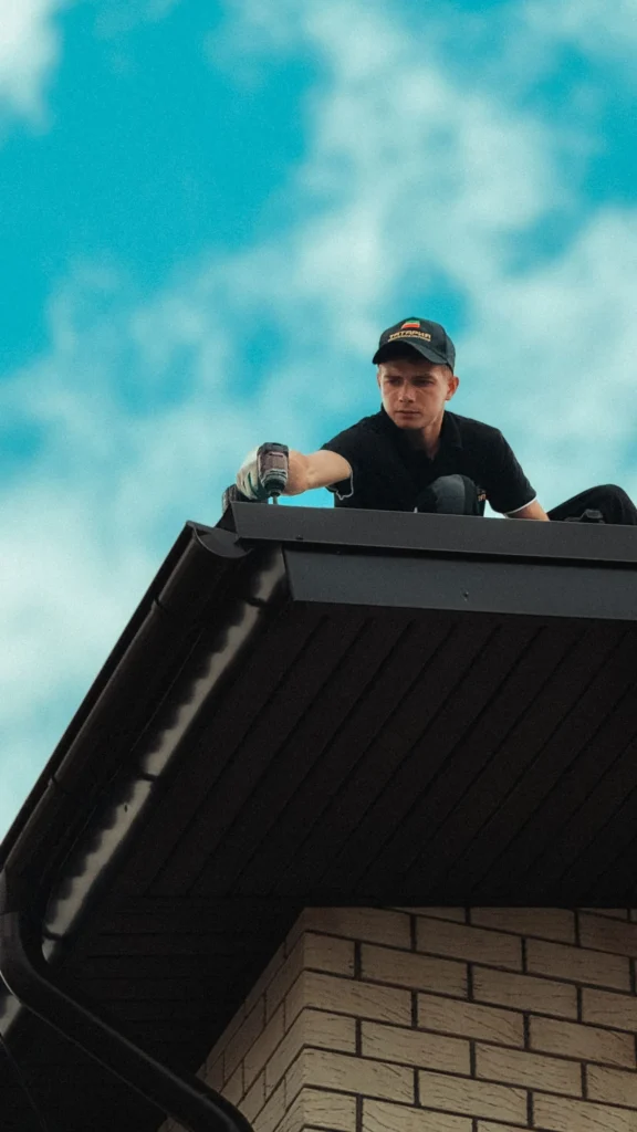 Two professional roofers repairing a tile roof in Allen TX during emergency roof leak repair service